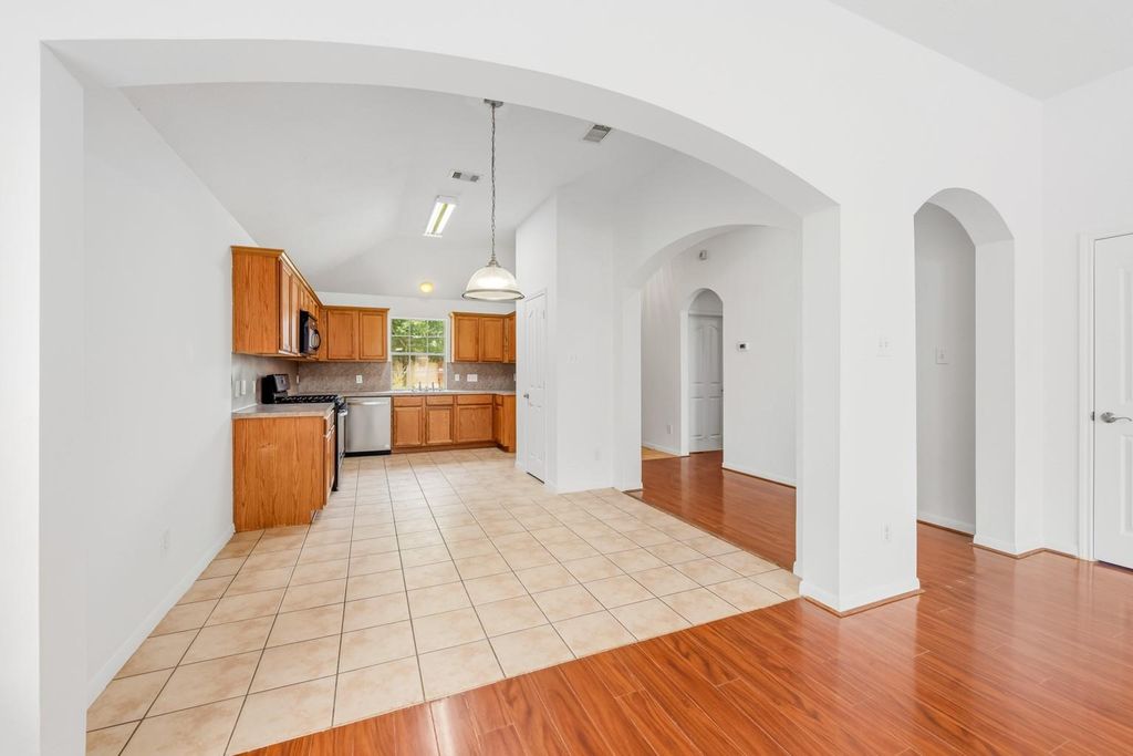 4908 Summer Rain Dr, Conroe, TX 77303 View through an archway into an open concept kitchen