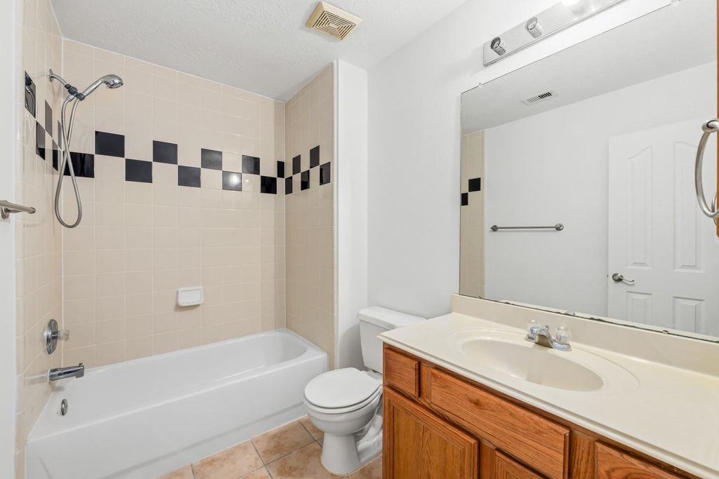 4908 Summer Rain Dr, Conroe, TX 77303 Bathroom interior with a bathtub and tile surround